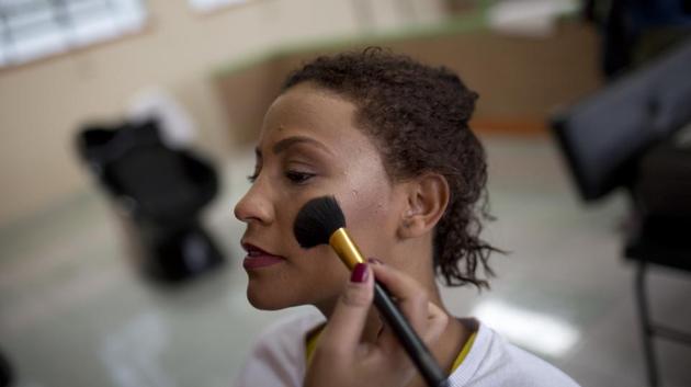 An inmate keeps still as an event volunteer applies her blush for the annual beauty contest. (Silvia Izquierdo / AP) An inmate keeps still as an event volunteer applies her blush for the annual beauty contest. (Silvia Izquierdo / AP)