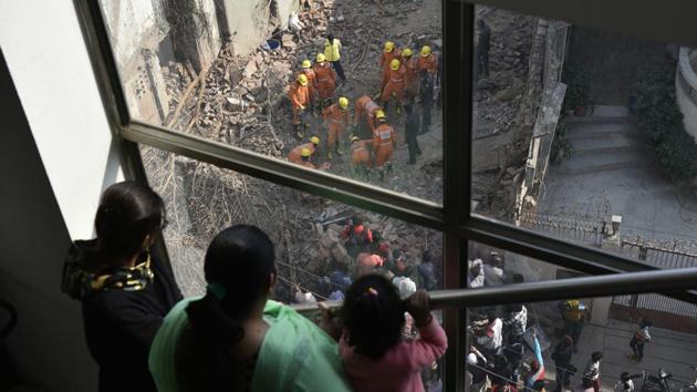 National Disaster Response Force (NDRF) officials remove debris after a building collapsed at Taimur Nagar in New Delhi on November 24, 2017. Two persons — a retired government employee and a labourer were killed after being trapped under the rubble of the 50-year-old house. (Sanchit Khanna / HT PHOTO) National Disaster Response Force (NDRF) officials remove debris after a building collapsed at Taimur Nagar in New Delhi on November 24, 2017. Two persons — a retired government employee and a labourer were killed after being trapped under the rubble of the 50-year-old house. (Sanchit Khanna / HT PHOTO)