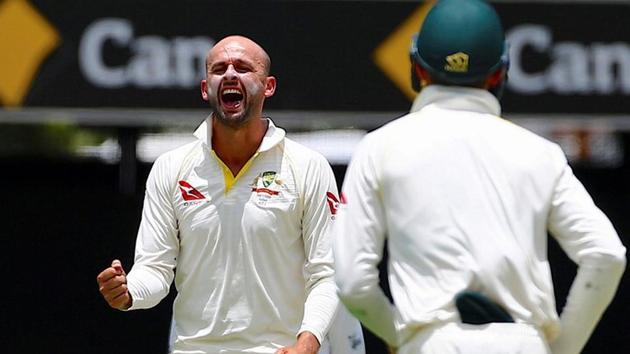 Australia's Nathan Lyon celebrates after dismissing England's Chris Woakes during the second day of the first Ashes cricket Test match.(Reuters)