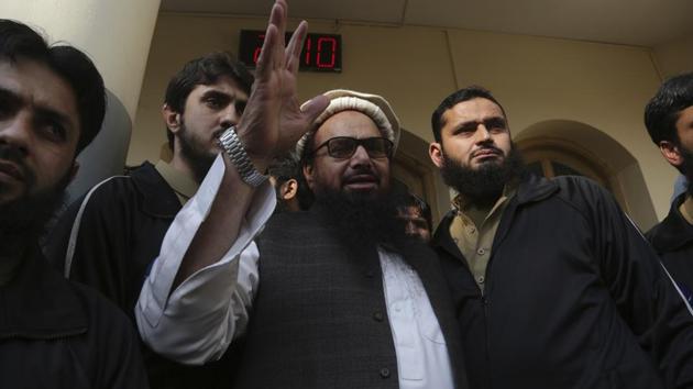 Hafiz Saeed, head of the Pakistani religious party, Jamaat-ud-Dawa, greets his supporters at a mosque in Lahore on Friday. (AP) Hafiz Saeed, head of the Pakistani religious party, Jamaat-ud-Dawa, greets his supporters at a mosque in Lahore on Friday. (AP)