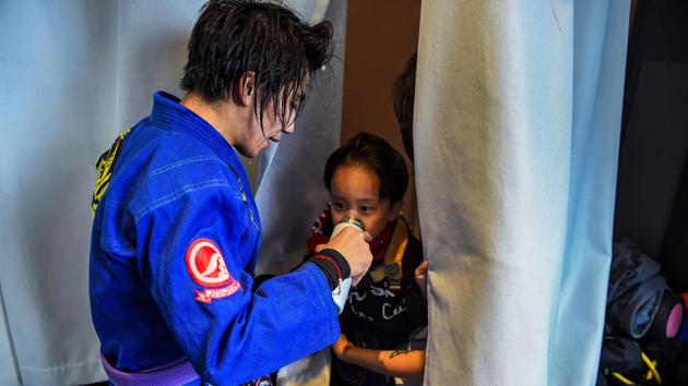 Outside the ring the Shanghai native is a dedicated parent to son Li Muyuan (R), arranging her five daily hours of training around his sleep and meals. (Chandan Khanna / AFP) Outside the ring the Shanghai native is a dedicated parent to son Li Muyuan (R), arranging her five daily hours of training around his sleep and meals. (Chandan Khanna / AFP)