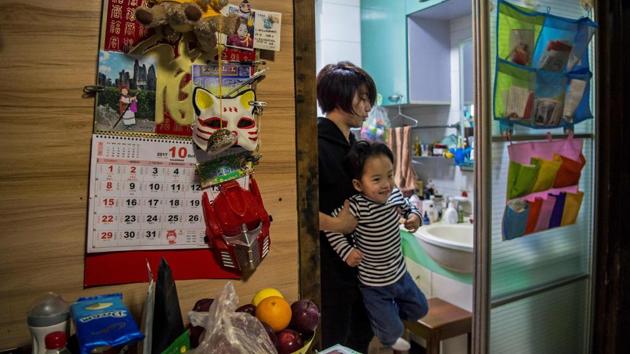 Miao gets her three-year-old son, Li Muyuan ready for school at their home in Shanghai. (Chandan Khanna / AFP) Miao gets her three-year-old son, Li Muyuan ready for school at their home in Shanghai. (Chandan Khanna / AFP)