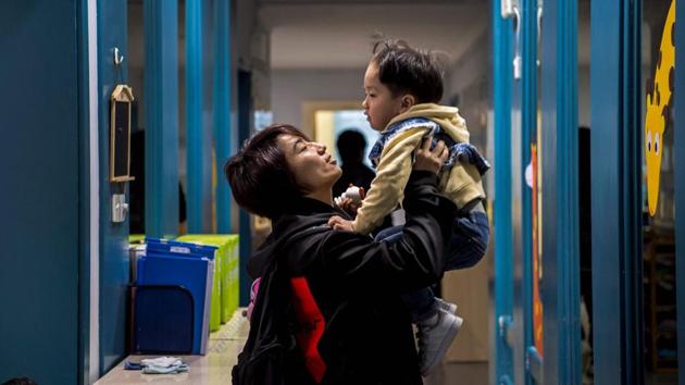 Miao bids goodbye as she drops Li Muyuan off to school in Shanghai. She says, “It’s like how some people listen to motivational music. My motivation is my son. Without my son, I feel like I can’t do anything.” (Chandan Khanna / AFP) Miao bids goodbye as she drops Li Muyuan off to school in Shanghai. She says, “It’s like how some people listen to motivational music. My motivation is my son. Without my son, I feel like I can’t do anything.” (Chandan Khanna / AFP)