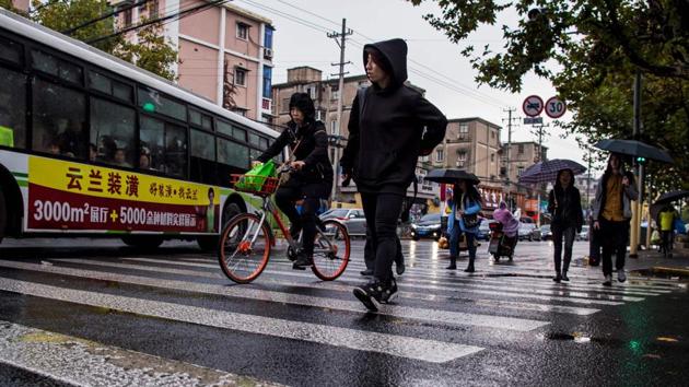 Miao Jie walks in the rain to catch a bus to her training centre in Shanghai. The sport will take a major step into the country on Saturday when ONE’s rival UFC --the world’s richest MMA promotion-- holds its first Fight Night in mainland China. (Chandan Khanna / AFP) Miao Jie walks in the rain to catch a bus to her training centre in Shanghai. The sport will take a major step into the country on Saturday when ONE’s rival UFC --the world’s richest MMA promotion-- holds its first Fight Night in mainland China. (Chandan Khanna / AFP)