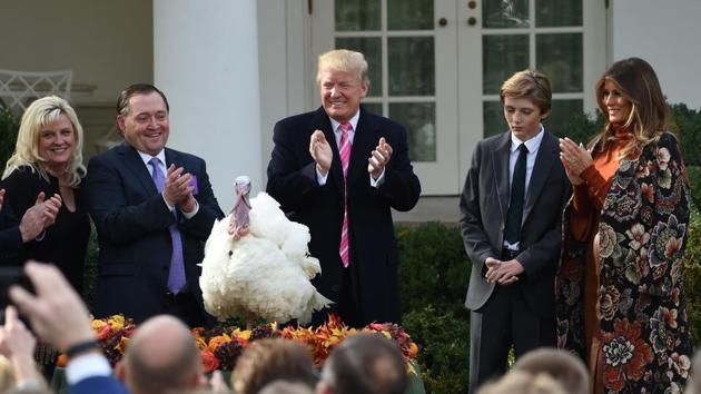 US President Donald Trump claps after the ceremonial White House pardoning of the turkeys, Drumstick and Wishbone, as First Lady Melania Trump (R) and their son Barron look on in Washington, DC on November 21, 2017. (Andrew Caballero-Reynolds / AFP) US President Donald Trump claps after the ceremonial White House pardoning of the turkeys, Drumstick and Wishbone, as First Lady Melania Trump (R) and their son Barron look on in Washington, DC on November 21, 2017. (Andrew Caballero-Reynolds / AFP)
