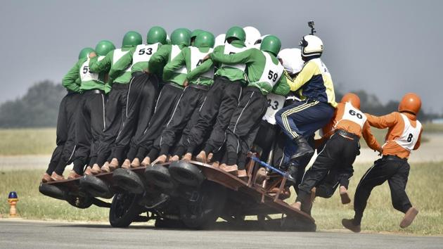 Members of Army Service Corps "Tornadoes" lose control during the second attempt for the World record of most men on one motorcycle at Indian Air Force station in Bengaluru on Sunday, November 19, 2017. (Arijit Sen / HT Photo) Members of Army Service Corps "Tornadoes" lose control during the second attempt for the World record of most men on one motorcycle at Indian Air Force station in Bengaluru on Sunday, November 19, 2017. (Arijit Sen / HT Photo)