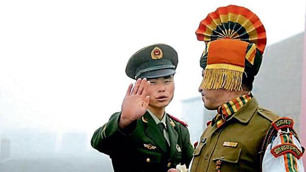 A Chinese soldier gestures next to an Indian soldier at the Nathu La border crossing in Sikkim.(AFP File Photo)