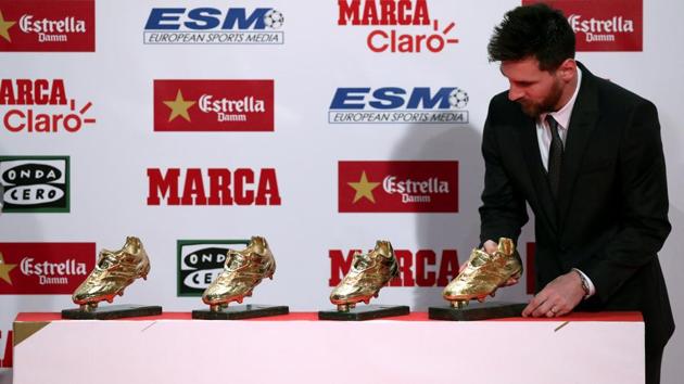 Lionel Messi puts his fourth Golden Boot trophy with the other three. (REUTERS)