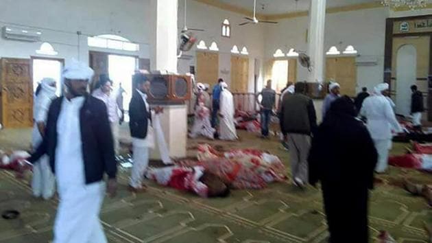 Egyptians walk past bodies following a gun and bombing attack at the Rawda mosque, roughly 40 kilometres west of the North Sinai capital of El-Arish, on November 24, 2017. (AFP Photo) Egyptians walk past bodies following a gun and bombing attack at the Rawda mosque, roughly 40 kilometres west of the North Sinai capital of El-Arish, on November 24, 2017. (AFP Photo)
