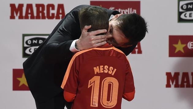 Lionel Messi even found time to celebrate with a young fan of his after receiving the award. (AFP)