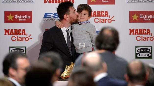 Lionel Messi kisses his son Thiago after receiving the 2017 European Golden Shoe award. (AFP)