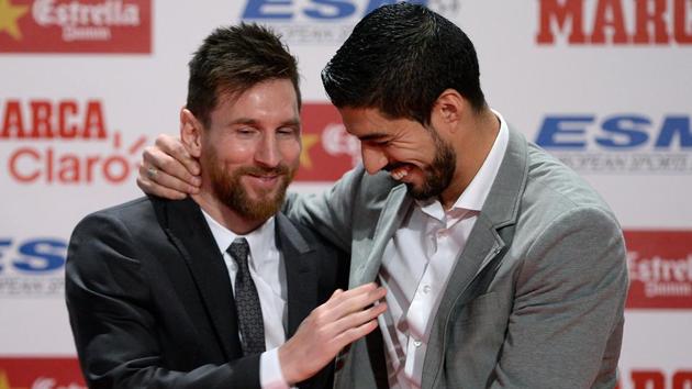 Lionel Messi is congratulated by Luis Suarez after he equalled rival Cristiano Ronaldo’s haul of four European Golden Shoe awards. (AFP)
