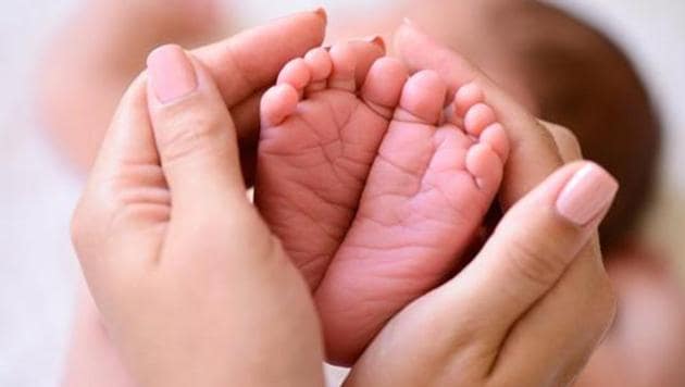 A mother holding the tiny feet of a newborn baby. (Getty Images/iStockphoto) A mother holding the tiny feet of a newborn baby. (Getty Images/iStockphoto)