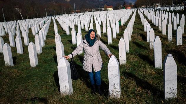 A woman mourns over a relative's grave at the memorial centre of Potocari near Srebrenica. United Nations judges on November 22, 2017 sentenced former Bosnian Serbian commander Ratko Mladic to life imprisonment after finding him guilty of genocide and war crimes in the brutal Balkans conflicts over two decades ago. (Dimitar Dilkoff / AFP) A woman mourns over a relative's grave at the memorial centre of Potocari near Srebrenica. United Nations judges on November 22, 2017 sentenced former Bosnian Serbian commander Ratko Mladic to life imprisonment after finding him guilty of genocide and war crimes in the brutal Balkans conflicts over two decades ago. (Dimitar Dilkoff / AFP)