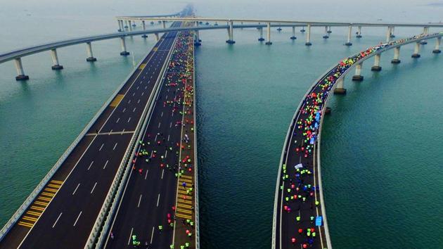 This photo taken on November 19, 2017 shows participants crossing the Jiaozhou Bay Bridge as they compete in the 2017 Qingdao International Marathon on the Sea in Qingdao in China's eastern Shandong province. (AFP) This photo taken on November 19, 2017 shows participants crossing the Jiaozhou Bay Bridge as they compete in the 2017 Qingdao International Marathon on the Sea in Qingdao in China's eastern Shandong province. (AFP)