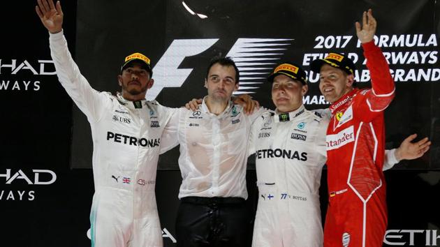 Mercedes' Valtteri Bottas (2nd R) won the Formula One Abu Dhabi Grand Prix ahead of teammate Lewis Hamilton (L) and Ferrari's Sebastian Vettel (R).(Reuters)