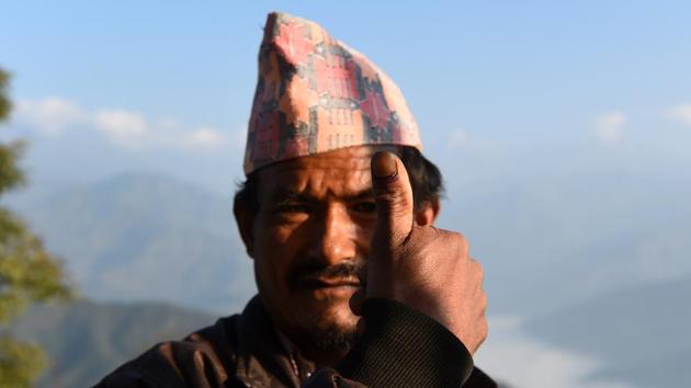 A Nepali voter shows his marked finger after casting his ballot at a polling station during the general election at Chautara, Sindhupalchowk district some of 100km east of Kathmandu on Sunday. (AFP Photo) A Nepali voter shows his marked finger after casting his ballot at a polling station during the general election at Chautara, Sindhupalchowk district some of 100km east of Kathmandu on Sunday. (AFP Photo)