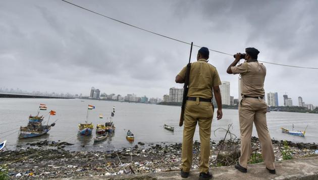 A police commando stands guard by the sea coast at Geeta Nagar, Colaba, after a high alert was issued in Mumbai, on September 23, 2016.