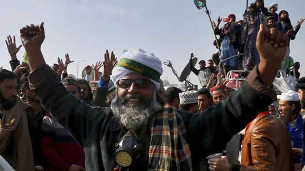 Supporters of the radical religious party Tehreek-e-Labbaik Pakistan celebrate after law minister Zahid Hamid's resignation during a sit-in protest in Islamabad on November 27, 2017. Pakistani Islamists announced they were disbanding their sit-in after the law minister resigned, caving in to the protesters who had been demanding his ouster in a three-week-long rally. (AP) Supporters of the radical religious party Tehreek-e-Labbaik Pakistan celebrate after law minister Zahid Hamid's resignation during a sit-in protest in Islamabad on November 27, 2017. Pakistani Islamists announced they were disbanding their sit-in after the law minister resigned, caving in to the protesters who had been demanding his ouster in a three-week-long rally. (AP)