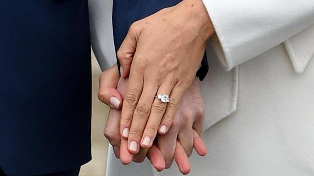 Meghan Markle’s engagement ring sparkles as she poses with Prince Harry in the Sunken Garden of Kensington Palace on November 27, 2017 in London, Britain. Harry and Markle, who is a divorcee, met in July 2016 after they were introduced through friends. (Eddie Mulholland / Pool / REUTERS)
