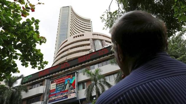 A man looks at a screen across a road displaying the Sensex on the facade of the Bombay Stock Exchange (BSE) building in Mumbai. (Reuters File Photo) A man looks at a screen across a road displaying the Sensex on the facade of the Bombay Stock Exchange (BSE) building in Mumbai. (Reuters File Photo)