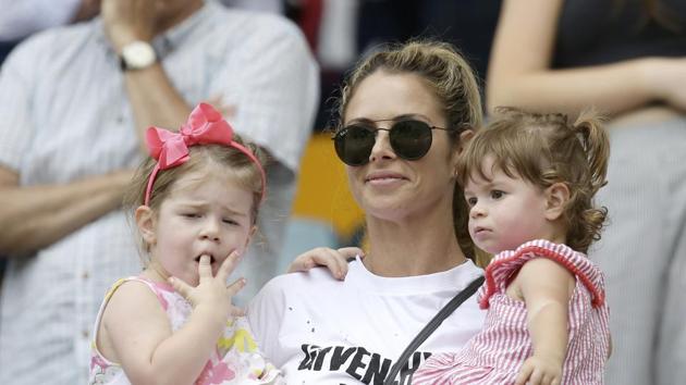Candice Warner, the wife of Australia's David Warner, watches with their children Ivy Mae, left, and Indi Rae, as the Australian team celebrated. (AP)