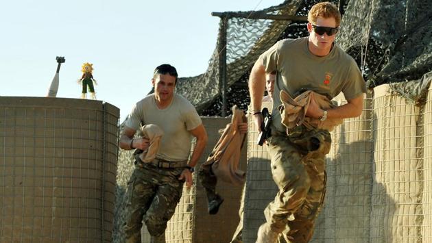 Prince Harry (R) scrambles to his Apache with a fellow pilot at the British controlled flight-line in Afghanistan in November 2012. Harry’s teenage years were overshadowed by negative press headlines but he turned his around image after joining the army, where he spent 10 years. He said it was a role where he felt he could be himself without media scrutiny or the trappings of his gilded upbringing. (John Stillwell / AFP)