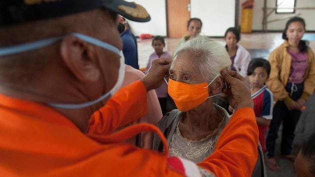 An officer with the disaster management agency BPBD places a mask on an elderly woman at a shelter for residents in Bebandem Village, Indonesia. Agung rumbled back to life earlier in September, forcing the evacuation of 140,000 people living nearby. Its activity decreased in late October and many had returned to their homes. (Antara Foto / Nyoman Budhiana / REUTERS) An officer with the disaster management agency BPBD places a mask on an elderly woman at a shelter for residents in Bebandem Village, Indonesia. Agung rumbled back to life earlier in September, forcing the evacuation of 140,000 people living nearby. Its activity decreased in late October and many had returned to their homes. (Antara Foto / Nyoman Budhiana / REUTERS)