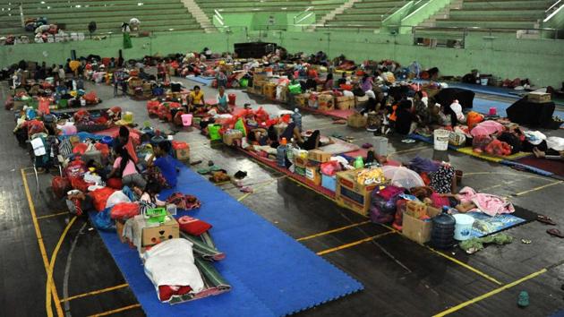 Residents spent the night at evacuation centres after Mount Agung erupted for a second time within a week on November 25, 2017. Authorities estimate another 60,000 people still need to move out of imminent danger. The governor of Bali has said a further 150,000 could be called on to evacuate. (Sonny Tumbelaka / AFP) Residents spent the night at evacuation centres after Mount Agung erupted for a second time within a week on November 25, 2017. Authorities estimate another 60,000 people still need to move out of imminent danger. The governor of Bali has said a further 150,000 could be called on to evacuate. (Sonny Tumbelaka / AFP)