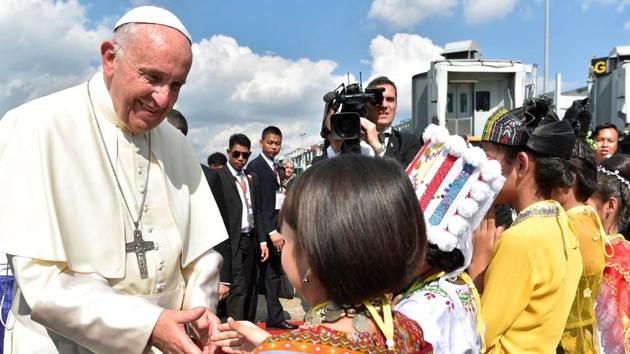 This handout picture released by the Vatican press office (Osservatore Romano) on November 27 shows Pope Francis being greeted by children upon his arrival at Yangon International Airport. (AFP Photo) This handout picture released by the Vatican press office (Osservatore Romano) on November 27 shows Pope Francis being greeted by children upon his arrival at Yangon International Airport. (AFP Photo)