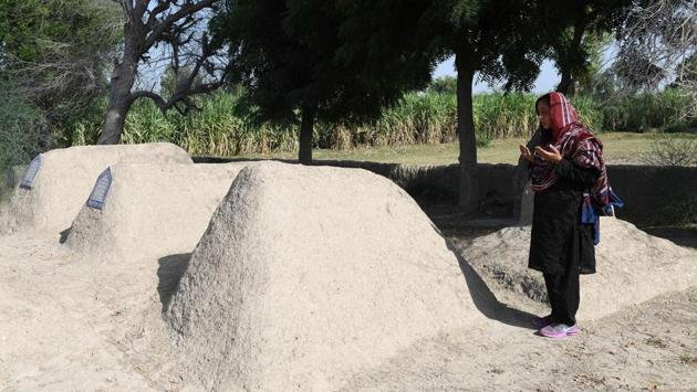 Dharejo offers prayer at the graves of her relatives in Qazi Ahmed. As 200 armed men surrounded her home on a hot August night in 2005, Nazo Dharejo, her sisters, husband and some loyal friends grabbed their Kalashnikov and puny stock of ammunition and climbed to the roof as household staff made daring runs for ammunition until daylight broke. (Asif Hassan / AFP) Dharejo offers prayer at the graves of her relatives in Qazi Ahmed. As 200 armed men surrounded her home on a hot August night in 2005, Nazo Dharejo, her sisters, husband and some loyal friends grabbed their Kalashnikov and puny stock of ammunition and climbed to the roof as household staff made daring runs for ammunition until daylight broke. (Asif Hassan / AFP)