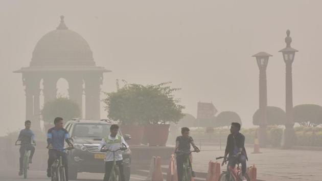 Cyclists ride along a road as heavy fog engulfs the city, at Raisina Hill, in New Delhi. (Sonu Mehta/HT File Photo) Cyclists ride along a road as heavy fog engulfs the city, at Raisina Hill, in New Delhi. (Sonu Mehta/HT File Photo)