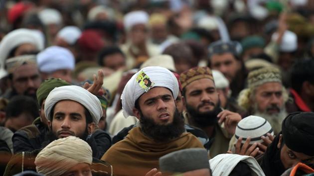 Supporters of the Tehreek-i-Labaik Yah Rasool Allah Pakistan (TLYRAP) religious group listen to their leader Khadim Hussain Rizvi while as he announces the end of sit-in protest on a blocked flyover bridge during a press conference in Islamabad on Monday. (AFP) Supporters of the Tehreek-i-Labaik Yah Rasool Allah Pakistan (TLYRAP) religious group listen to their leader Khadim Hussain Rizvi while as he announces the end of sit-in protest on a blocked flyover bridge during a press conference in Islamabad on Monday. (AFP)