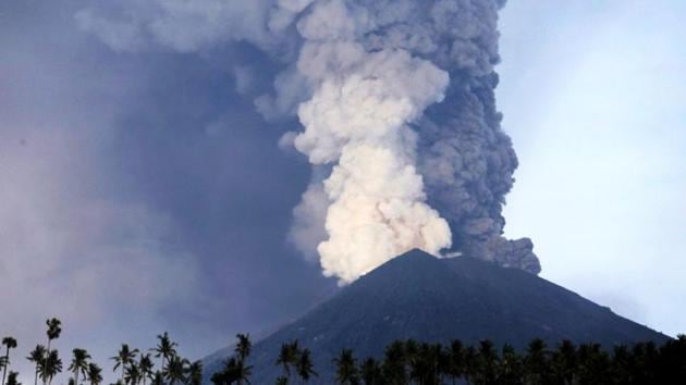 Plumes of ash billow from Mount Agung volcano as viewed from Culik village on November 27, 2017 in Bali, Indonesia. Indonesian authorities raised the alert as Mount Agung rumbled on the tourist island of Bali, ordering people within 10 kilometers to evacuate. Bali’s international airport has closed for 24 hours and authorities will consider reopening it Tuesday after evaluating the situation. (Johannes P. Christo / REUTERS) Plumes of ash billow from Mount Agung volcano as viewed from Culik village on November 27, 2017 in Bali, Indonesia. Indonesian authorities raised the alert as Mount Agung rumbled on the tourist island of Bali, ordering people within 10 kilometers to evacuate. Bali’s international airport has closed for 24 hours and authorities will consider reopening it Tuesday after evaluating the situation. (Johannes P. Christo / REUTERS)