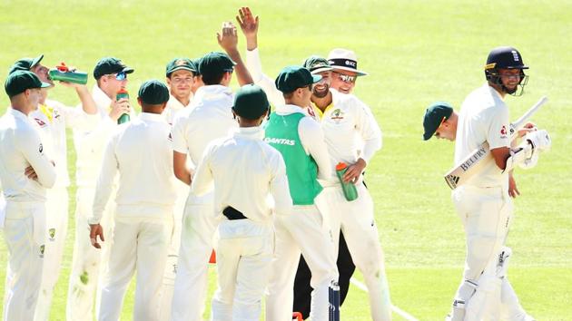 Mitchell Starc of Australia cricket team celebrates with his teammates after taking the wicket of Stuart Broad of England during day four of the First Ashes 2017-18 Test at The Gabba on November 26.(Getty Images)