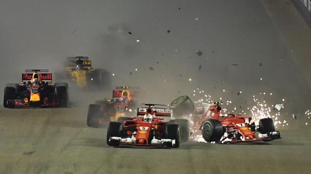 Ferrari F1 team drivers Kimi Raikkonen (R) and Sebastian Vettel (C) crash with each other during the Formula One Singapore Grand Prix on September 17, 2017, a turning point of the season.(AFP)