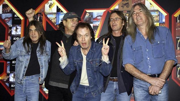 Malcolm Young, Brian Johnson, Angus Young, Phil Rudd and Cliff Williams from AC/DC pose for photographers at the Apollo Hammersmith in London, 2003. Young founded the group with Angus in 1973, and was a driving force in making it one of the biggest rocks acts in the world. (Yui Mok / AP) Malcolm Young, Brian Johnson, Angus Young, Phil Rudd and Cliff Williams from AC/DC pose for photographers at the Apollo Hammersmith in London, 2003. Young founded the group with Angus in 1973, and was a driving force in making it one of the biggest rocks acts in the world. (Yui Mok / AP)