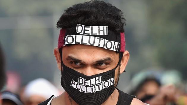 A participant highlights the issue of air pollution during the Airtel Delhi Half Marathon 2017 in New Delhi.(PTI FILE)