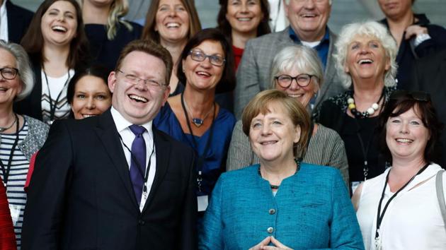 This file photo taken on May 17, 2017 shows German Chancellor Angela Merkel (right) posing with Altena's mayor Andreas Hollstein (left) and other winners of the national integration award at the Chancellery in Berlin. A knife attacker injured Hollstein in an assault which officials said appeared motivated by the municipal leader's pro-refugee stance. (AFP) This file photo taken on May 17, 2017 shows German Chancellor Angela Merkel (right) posing with Altena's mayor Andreas Hollstein (left) and other winners of the national integration award at the Chancellery in Berlin. A knife attacker injured Hollstein in an assault which officials said appeared motivated by the municipal leader's pro-refugee stance. (AFP)