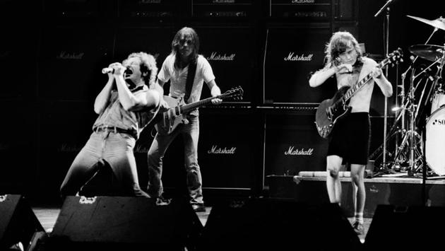 Brian Johnson performs next to guitarists Malcolm Young and Angus Young of the hard rock band AC/DC on September 15, 1984 in Paris. Best known for their hit song ‘Highway to Hell,’ AC/DC produced 17 studio albums, selling more than 200 million records. (Jean-Claude Coutausse / AFP) Brian Johnson performs next to guitarists Malcolm Young and Angus Young of the hard rock band AC/DC on September 15, 1984 in Paris. Best known for their hit song ‘Highway to Hell,’ AC/DC produced 17 studio albums, selling more than 200 million records. (Jean-Claude Coutausse / AFP)