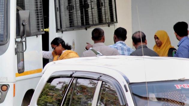 Hadiya (second from right in a yellow scarf) being escorted on her arrival at the Coimbatore airport on Tuesday.(PTI) Hadiya (second from right in a yellow scarf) being escorted on her arrival at the Coimbatore airport on Tuesday.(PTI)