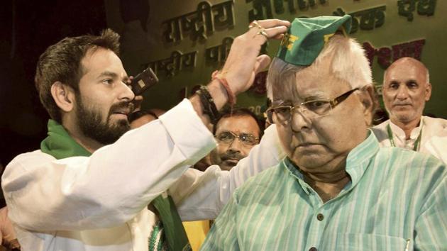 RJD leader Tej Pratap Yadav offers a cap to party chief and his father Lalu Prasad on being re-elected as party president during the party's National Council meeting in Patna on November 21, 2017. (PTI File Photo) RJD leader Tej Pratap Yadav offers a cap to party chief and his father Lalu Prasad on being re-elected as party president during the party's National Council meeting in Patna on November 21, 2017. (PTI File Photo)