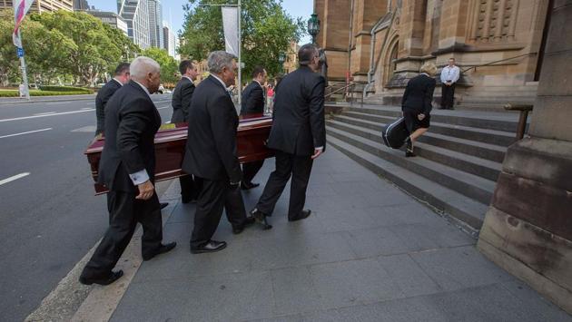 The casket is carried into the church for the funeral service of Malcolm Young at St Mary's Cathedral in Sydney. Young died on November 18, aged 64, after years of ill health. According to the Australian Broadcasting Corporation, those at the service were given guitar picks with their programs and Malcolm’s Gretsch guitar, which he called “the beast”, rested on top of his casket throughout. (Michele Mossop / Getty Images) The casket is carried into the church for the funeral service of Malcolm Young at St Mary's Cathedral in Sydney. Young died on November 18, aged 64, after years of ill health. According to the Australian Broadcasting Corporation, those at the service were given guitar picks with their programs and Malcolm’s Gretsch guitar, which he called “the beast”, rested on top of his casket throughout. (Michele Mossop / Getty Images)