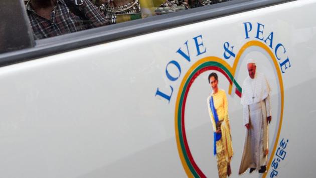 A sticker of Myanmar's State Counselor Aung San Suu Kyi (L) and Pope Franicsis displayed on a car in the streets of downtown Yangon, after the pope's arrival to Myanmar for a four-day official visit. (AFP Photo) A sticker of Myanmar's State Counselor Aung San Suu Kyi (L) and Pope Franicsis displayed on a car in the streets of downtown Yangon, after the pope's arrival to Myanmar for a four-day official visit. (AFP Photo)
