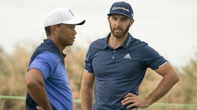 Dustin Johnson (right) talks to Tiger Woods on the practice green during Monday's practice round of the Hero World Challenge golf tournament at Albany.(USA TODAY Sports)