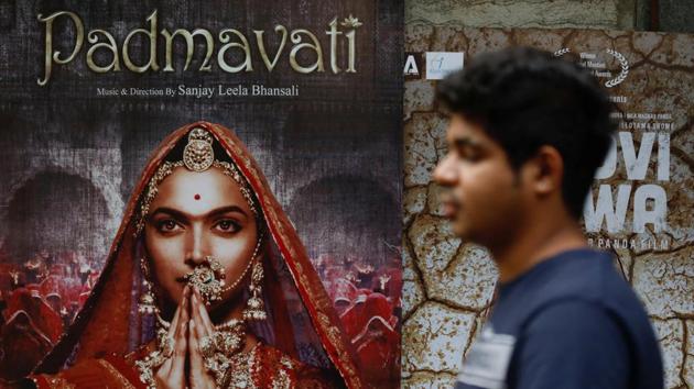 A man walks past a poster of the upcoming movie 'Padmavati' outside a theatre in Mumbai.(REUTERS)