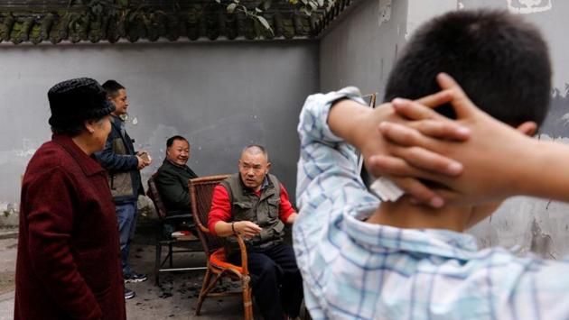 Xiong Gaowu (C), engages with customers during a break on a workday. When Xiong runs his razor, it is most likely that he shaves the openings of the sebaceous glands which cause discomfort and dryness in the eye when they are blocked, hence the demand for this technique, Qu theorised. (Tyrone Siu / REUTERS) Xiong Gaowu (C), engages with customers during a break on a workday. When Xiong runs his razor, it is most likely that he shaves the openings of the sebaceous glands which cause discomfort and dryness in the eye when they are blocked, hence the demand for this technique, Qu theorised. (Tyrone Siu / REUTERS)