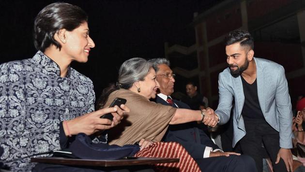 Indian cricket captain Kohli greets Sharmila Tagore as Anjum Chopra looks on during the DDCA's 1st Annual Conclave. (PTI)
