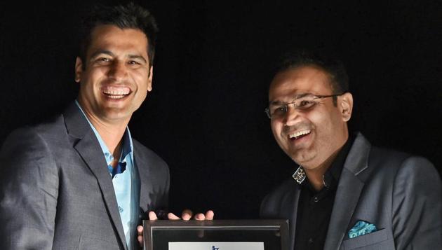 Former India fast bowler Amit Bhandari felicitates former India opener Virender Sehwag. (PTI)