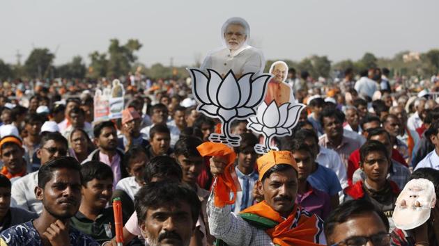 Supporters of the BJP hold party symbols with photographs of PM Narendra Modi, centre, and party president Amit Shah during an election campaign rally at Morbi in Gujarat on Wednesday. (AP) Supporters of the BJP hold party symbols with photographs of PM Narendra Modi, centre, and party president Amit Shah during an election campaign rally at Morbi in Gujarat on Wednesday. (AP)